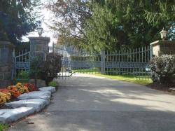 Custom design gray gate with control box located near roadway