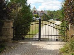 Stylish Black Metal Gate with Stone Pillars